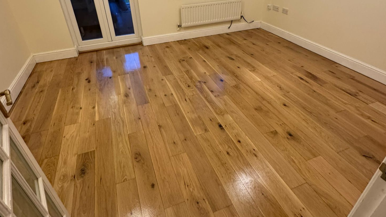 Freshly finished Wood Floor Sanding in Surbiton—an engineered oak hardwood plank floor with a smooth, satin sheen in a living room.
