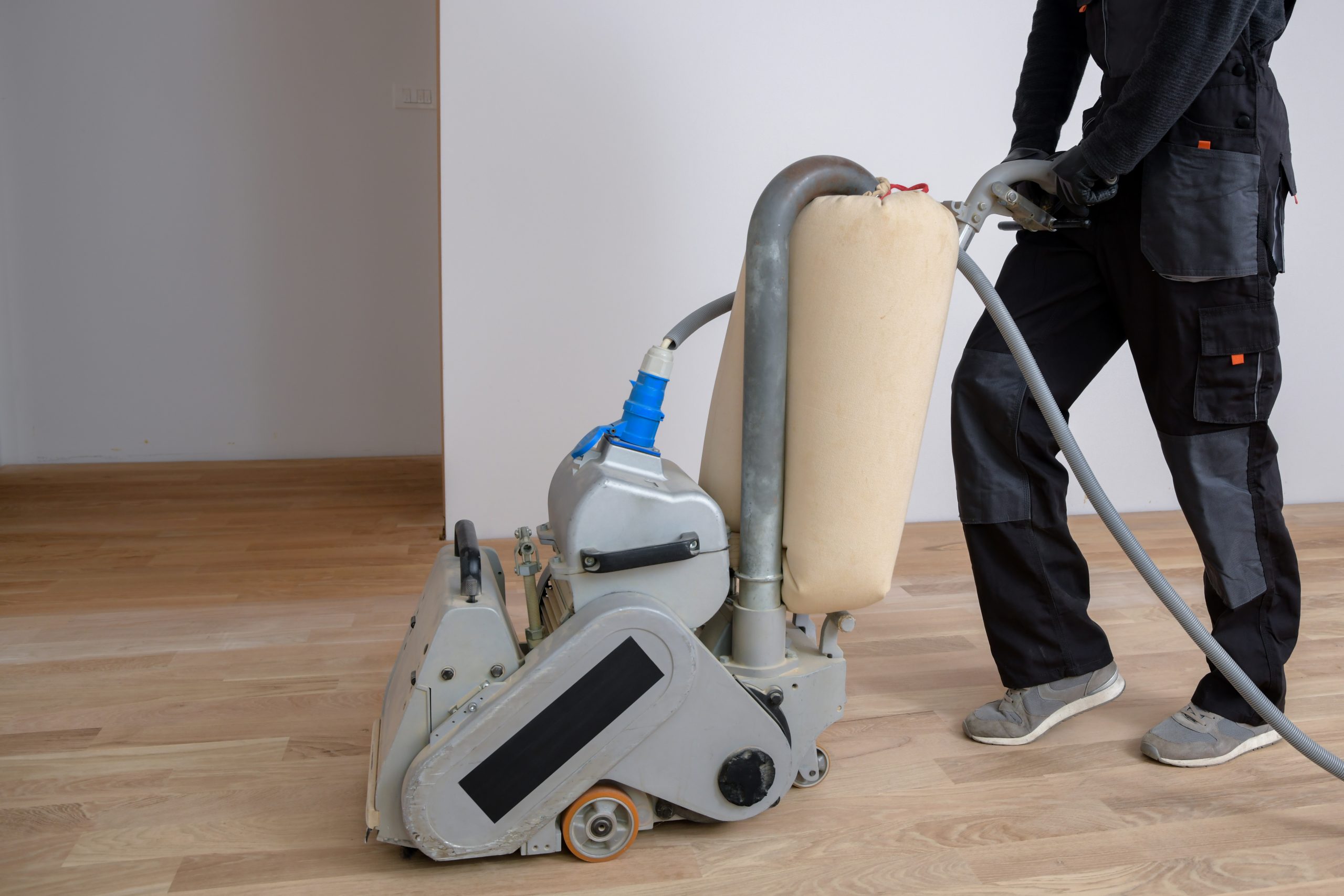 Professional Wood Floor Sanding in Surbiton on a light oak hardwood plank floor, using a dust-extraction belt sander.