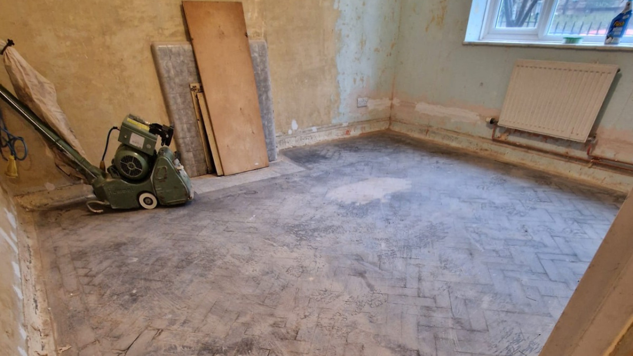 Parquet Floor Sanding Surbiton on Herringbone Wood Parquet Floor Before Restoration Parquet Floor Sanding in Surbiton showing a worn herringbone wood parquet floor before professional sanding and restoration