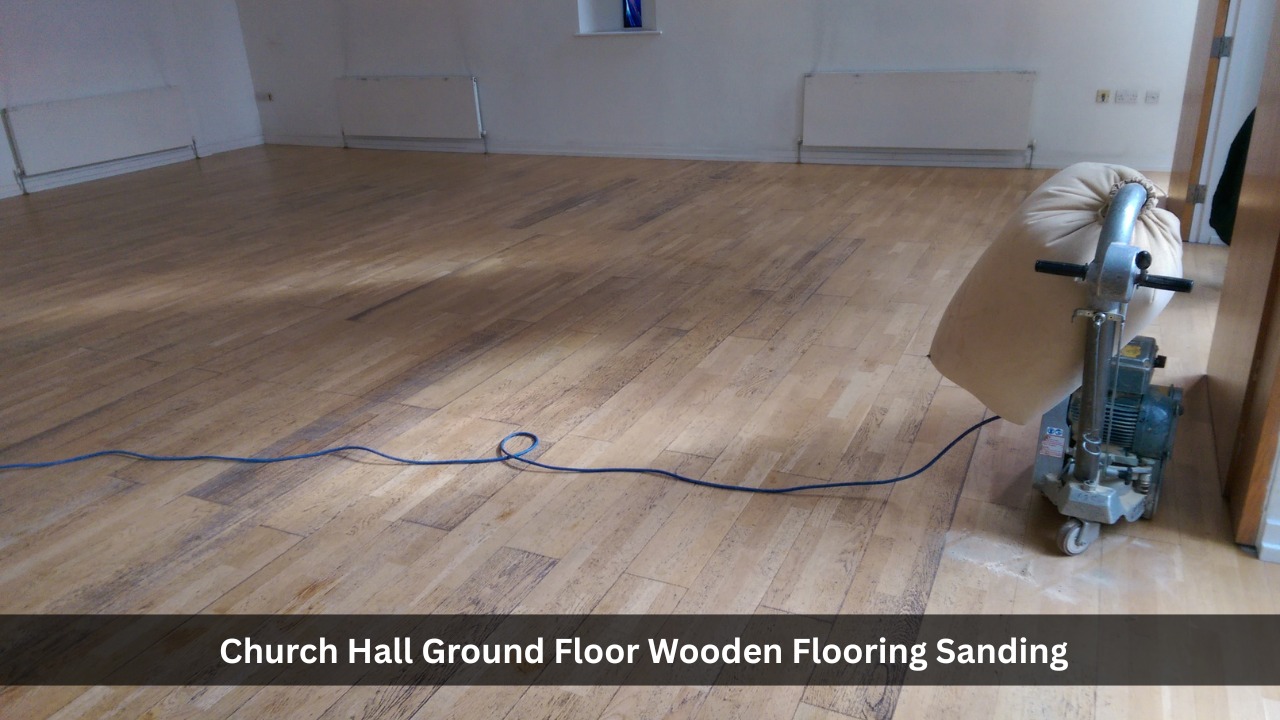 Professional floor sanding machine in use on a wooden church hall floor during dust-free restoration