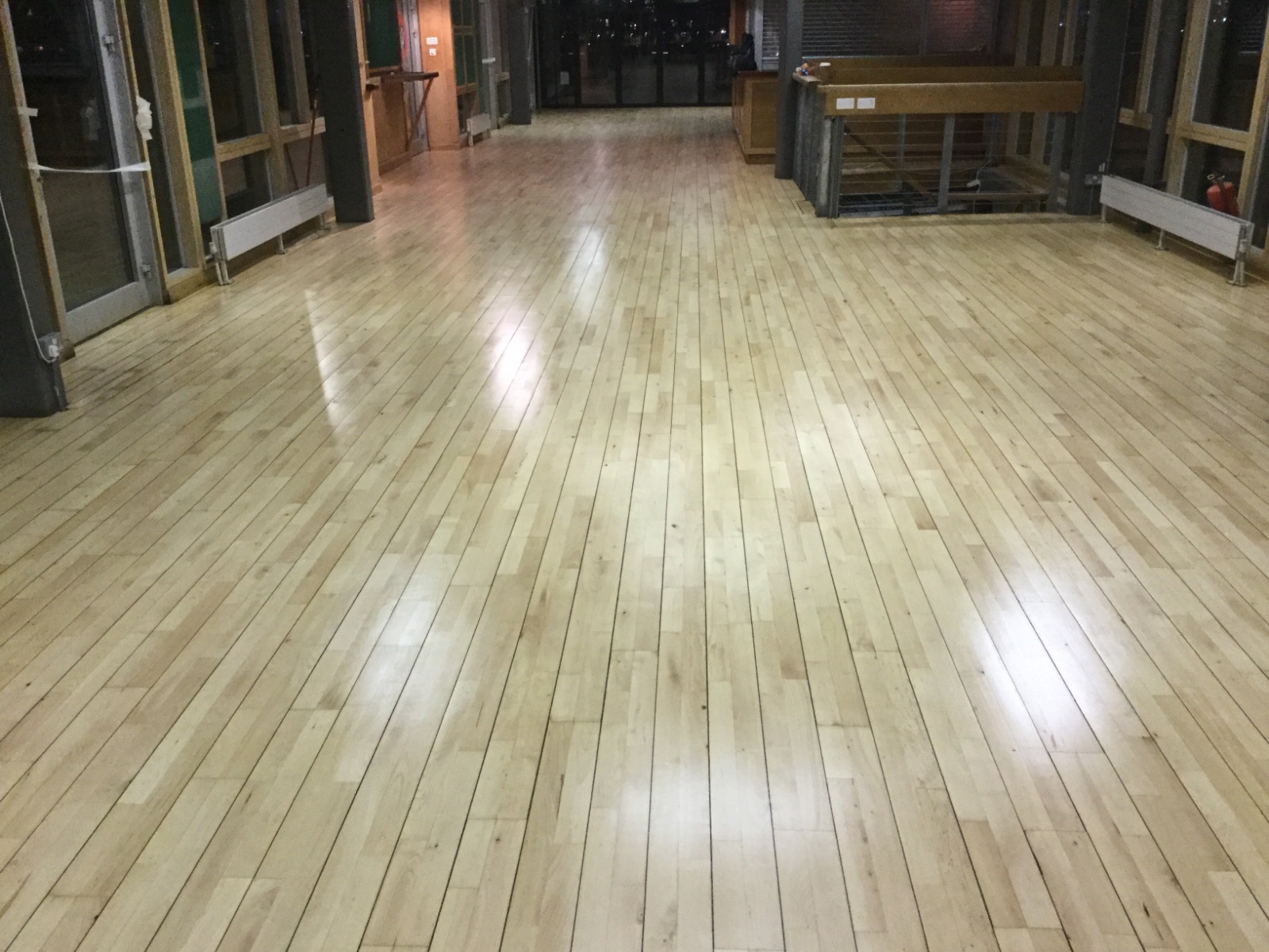 Community Hall Floor Sanding – Restored Wooden Floor Finish Restored light wooden strip floor in a community hall after professional dust-free floor sanding and sealing