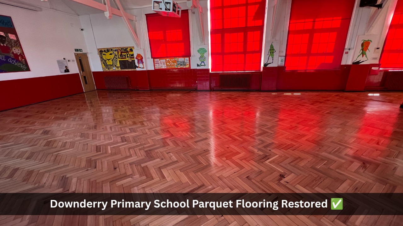 Restored herringbone parquet wooden floor in a school hall after professional floor sanding and sealing